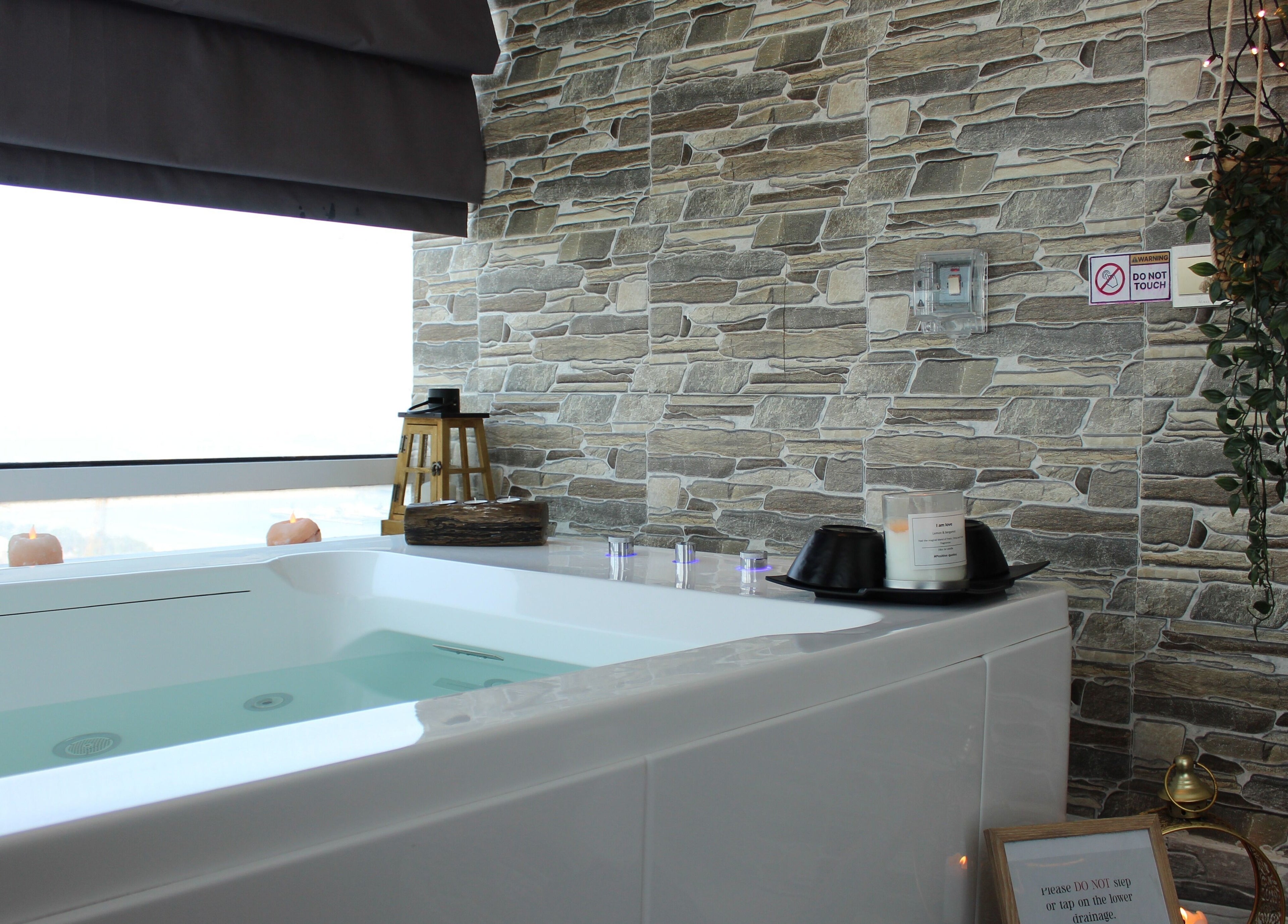 Luxurious bathtub with candles and decor at Zeerla Spa Media City, Dubai Media City, دبي, AE.