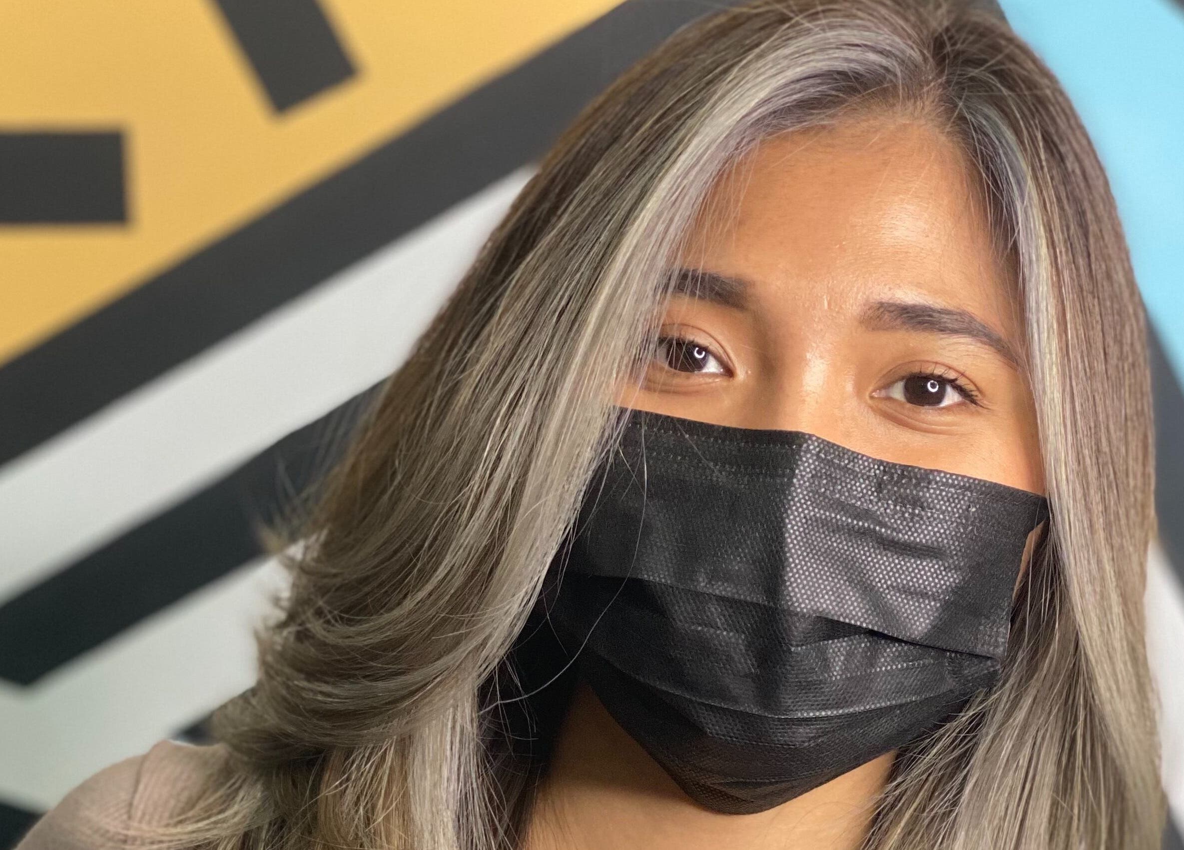 Woman with stylish hair at Mondrian Salon, Petaling Jaya, Selangor, MY, wearing a black mask.