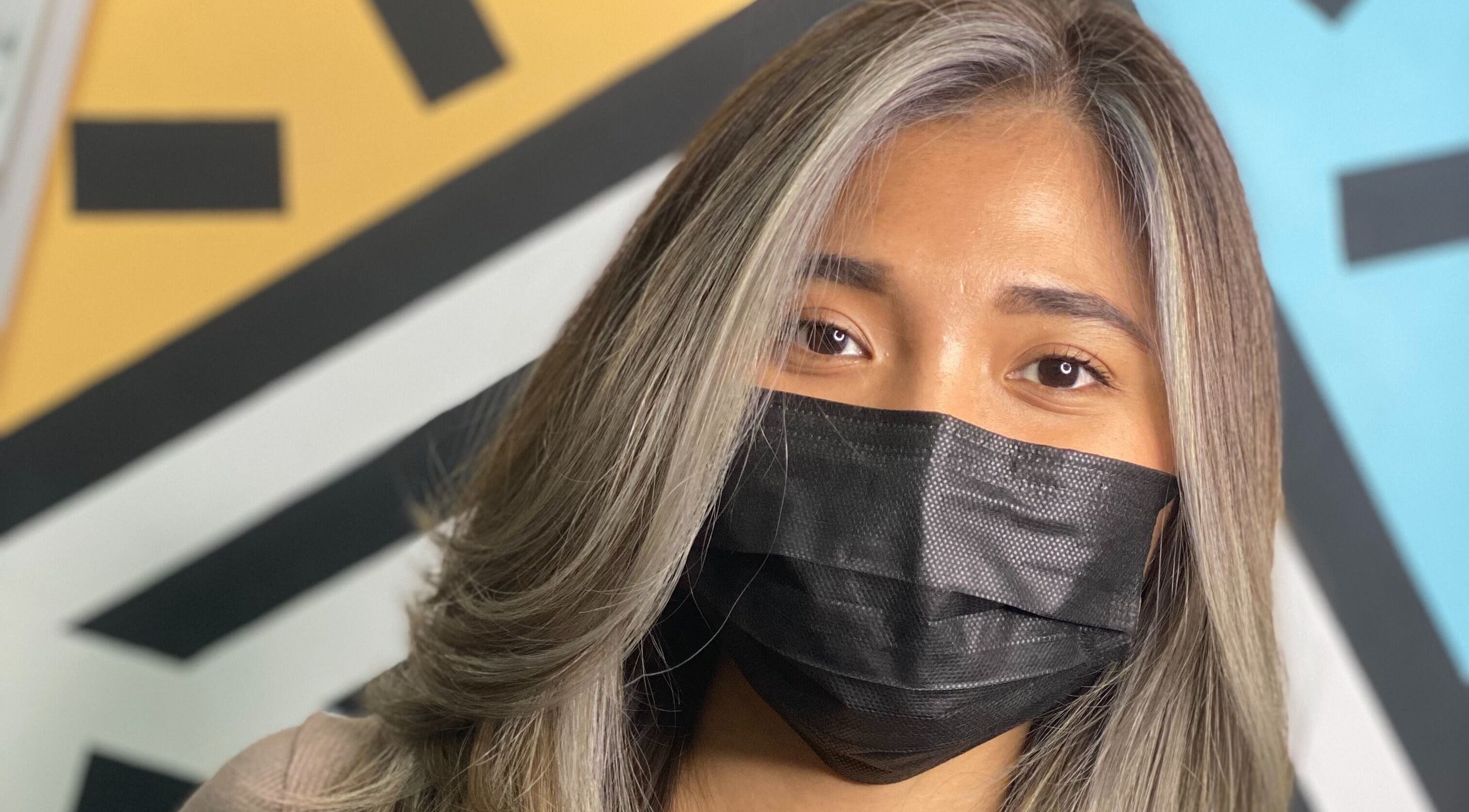 Woman with stylish hair at Mondrian Salon, Petaling Jaya, Selangor, MY, wearing a black mask.