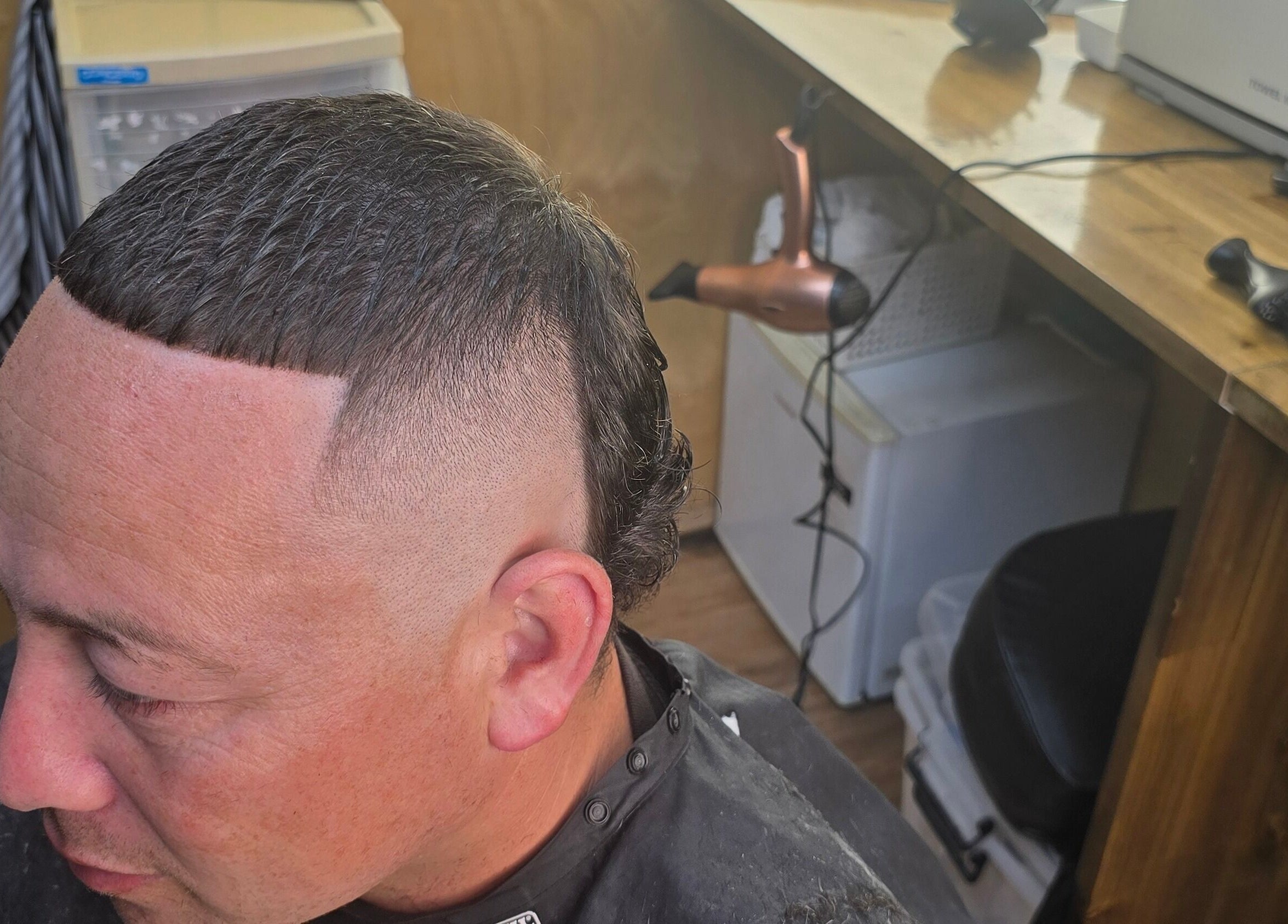 Stylish haircut at Si'z Kutzz, Waikato, Waikato, NZ, featuring precise fade and sleek styling.