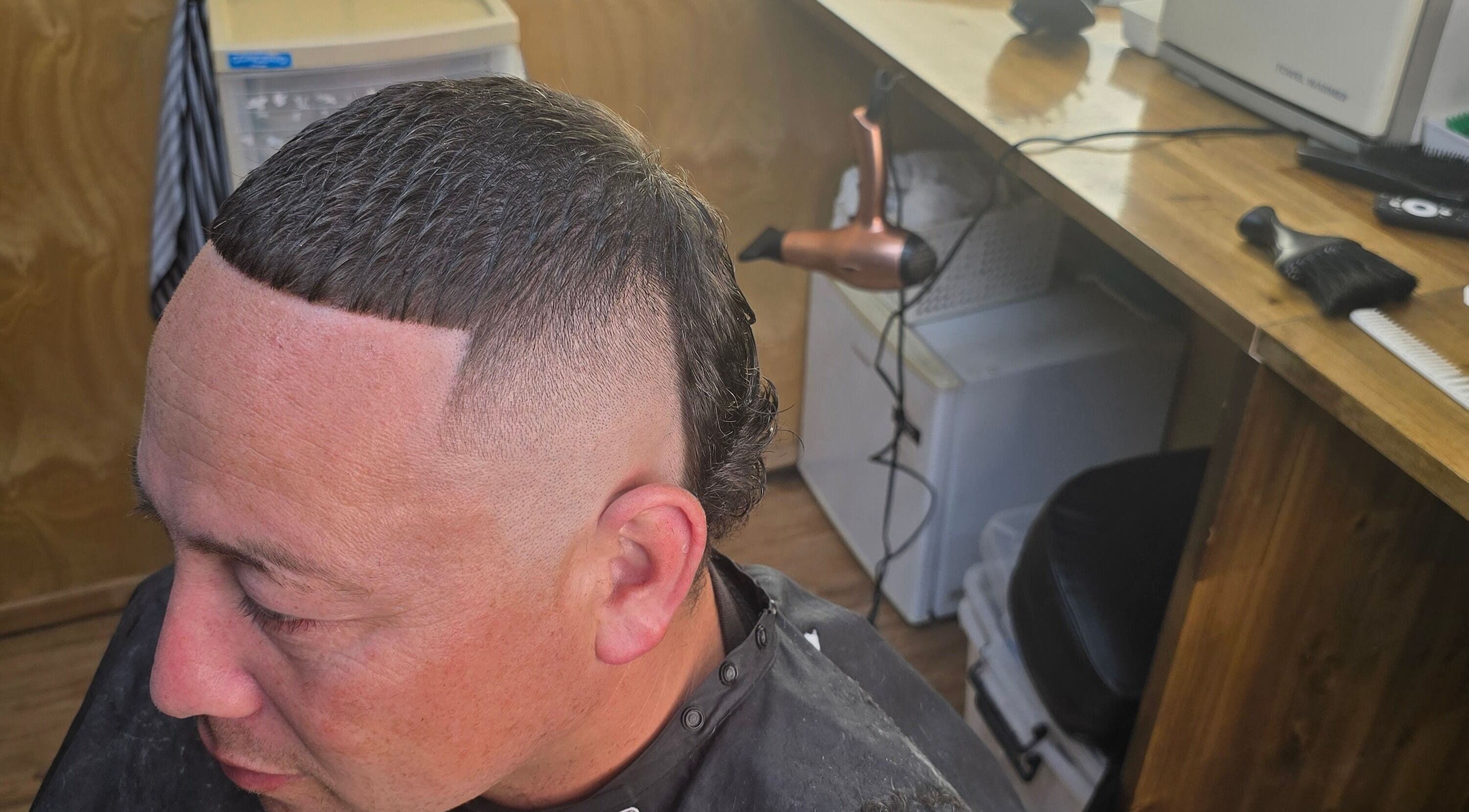 Stylish haircut at Si'z Kutzz, Waikato, Waikato, NZ, featuring precise fade and sleek styling.