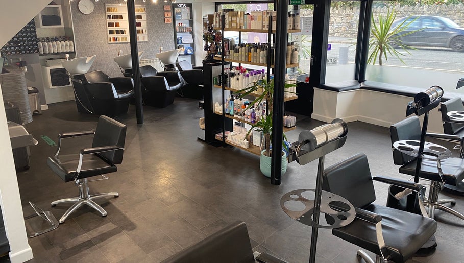 Modern interior of The Hive Hair • Beauty in St Austell, England, GB featuring sleek salon chairs and product display.