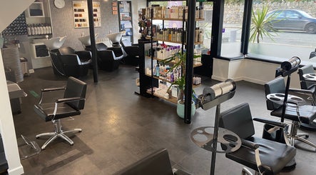 Modern interior of The Hive Hair • Beauty in St Austell, England, GB featuring sleek salon chairs and product display.