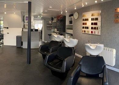Modern interior of The Hive Hair • Beauty in St Austell, showcasing sleek salon chairs and decor.