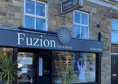 Exterior of The Hive Hair • Beauty, St Austell, England, featuring stylish signage.