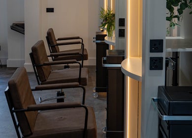 Elegant interior of The Hive Hair • Beauty, St Austell, England, GB with stylish salon chairs and modern lighting.