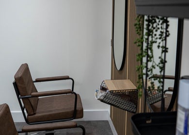 Modern salon seating at The Hive Hair • Beauty in St Austell, England, GB. Minimalist design and comfort.