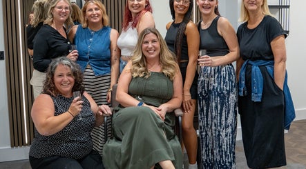 Team of stylists at The Hive Hair Beauty, St Austell, England, GB, celebrating together.