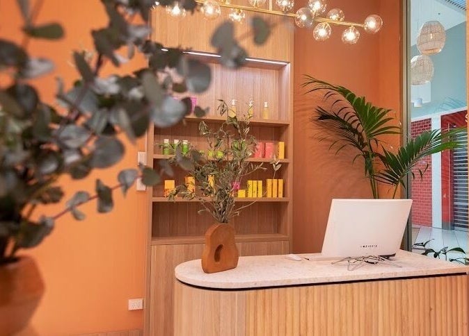 Reception at Valley Brow & Beauty Bar, Salamander Bay, New South Wales, AU with vibrant decor and lush plants.