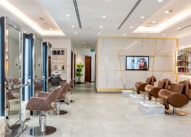 Modern and elegant salon interior at Legend Beauty Centre in Dubai, Dubai, AE, featuring sleek chairs and decor.