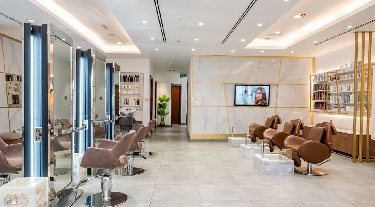 Modern and elegant salon interior at Legend Beauty Centre in Dubai, Dubai, AE, featuring sleek chairs and decor.