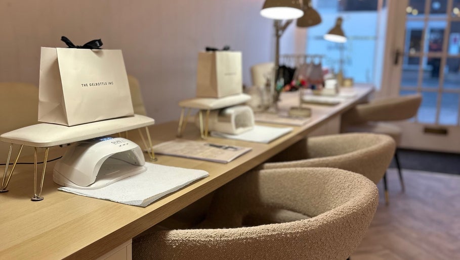 Elegant nail stations at The Nail Jar, Barnstaple, England, GB, featuring comfortable seating and manicure tools.