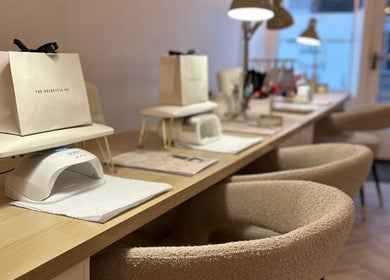 Elegant nail stations at The Nail Jar, Barnstaple, England, GB, featuring comfortable seating and manicure tools.