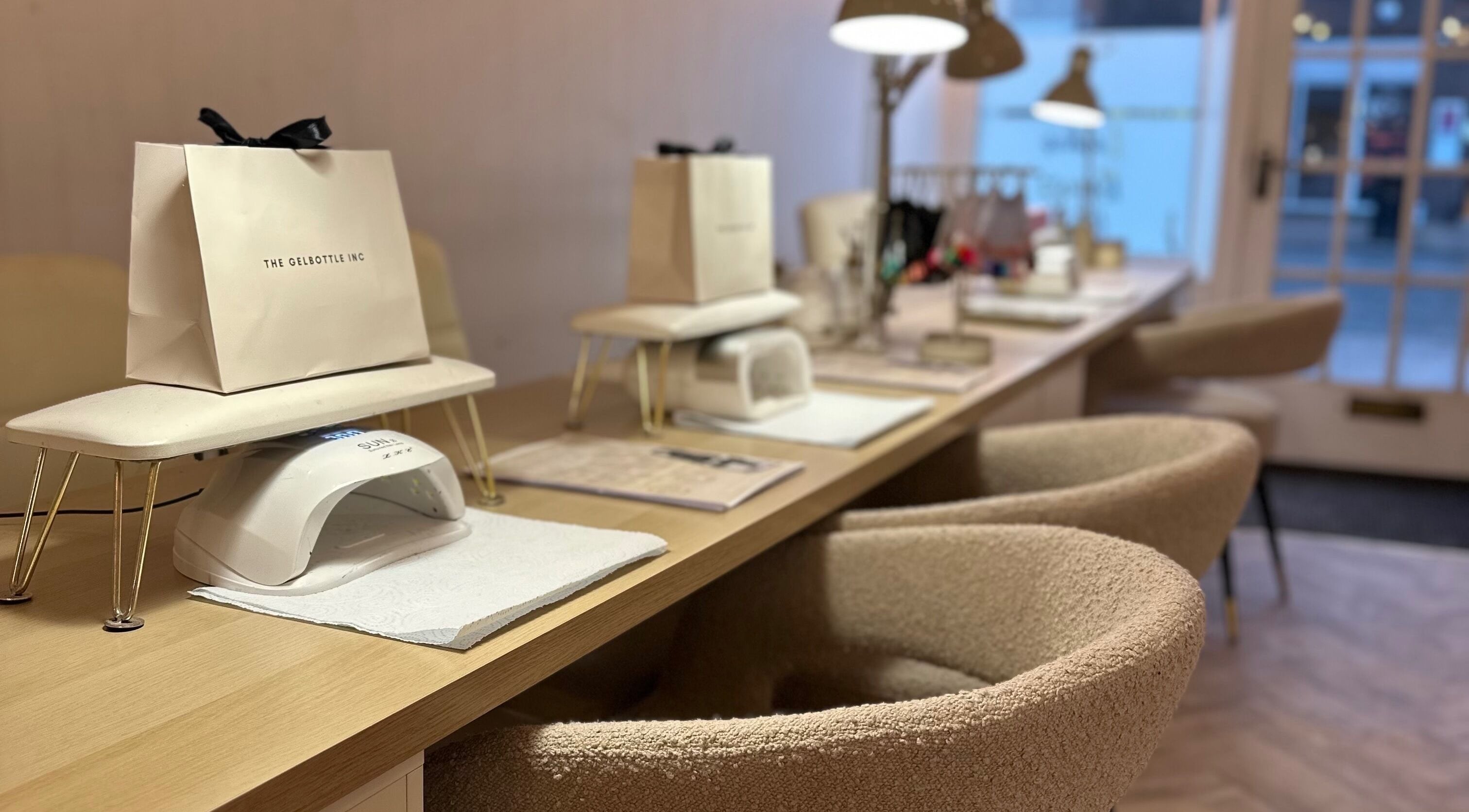 Elegant nail stations at The Nail Jar, Barnstaple, England, GB, featuring comfortable seating and manicure tools.