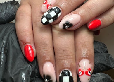 Stylish nail art at The Nail Jar, Barnstaple, England, GB featuring bold red and black patterns.