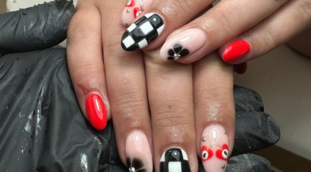 Stylish nail art at The Nail Jar, Barnstaple, England, GB featuring bold red and black patterns.