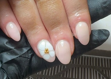 Detailed nail art with floral design at The Nail Jar, Barnstaple, England, GB, showcasing delicate beauty.