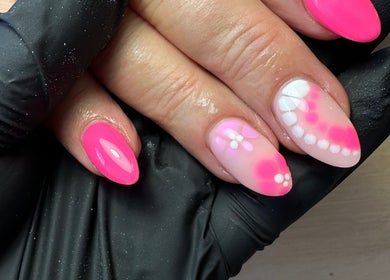 Close-up of vibrant pink and floral nail art at The Nail Jar, Barnstaple, England, GB.