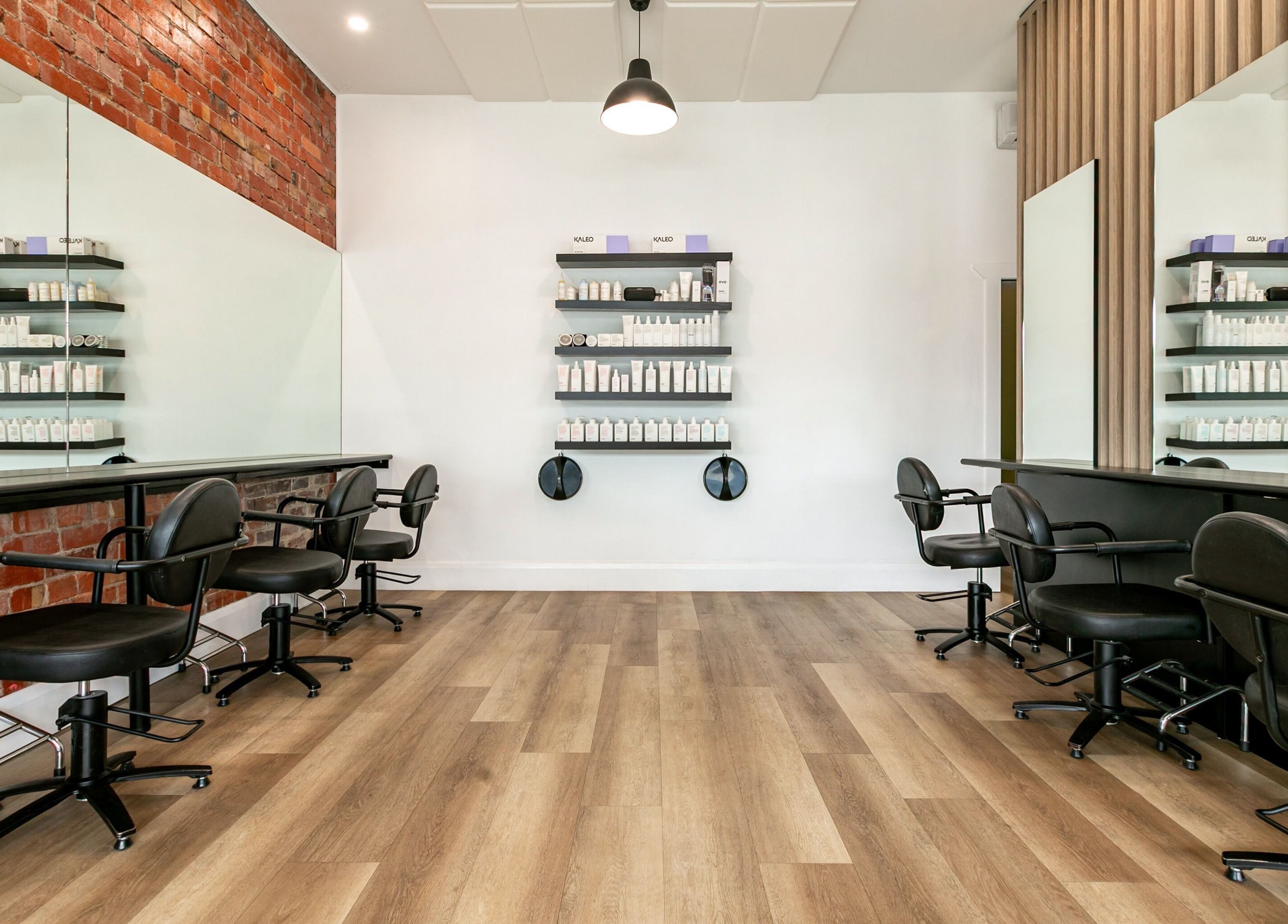 Modern salon interior at SP Salon, Melbourne, Victoria, AU with stylish chairs and product displays.