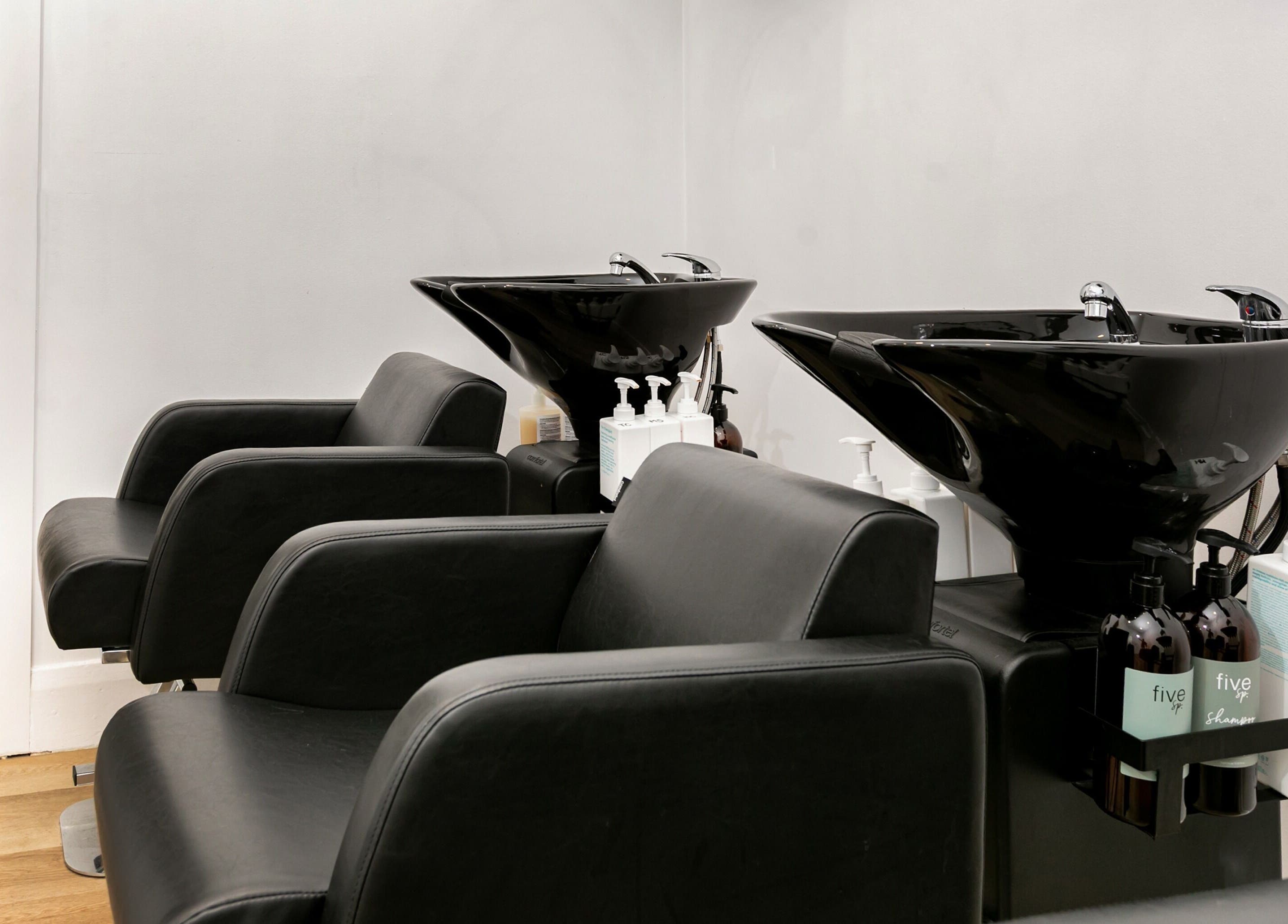 Chic wash stations at SP Salon, Melbourne, Victoria, AU with sleek black chairs and modern basins.