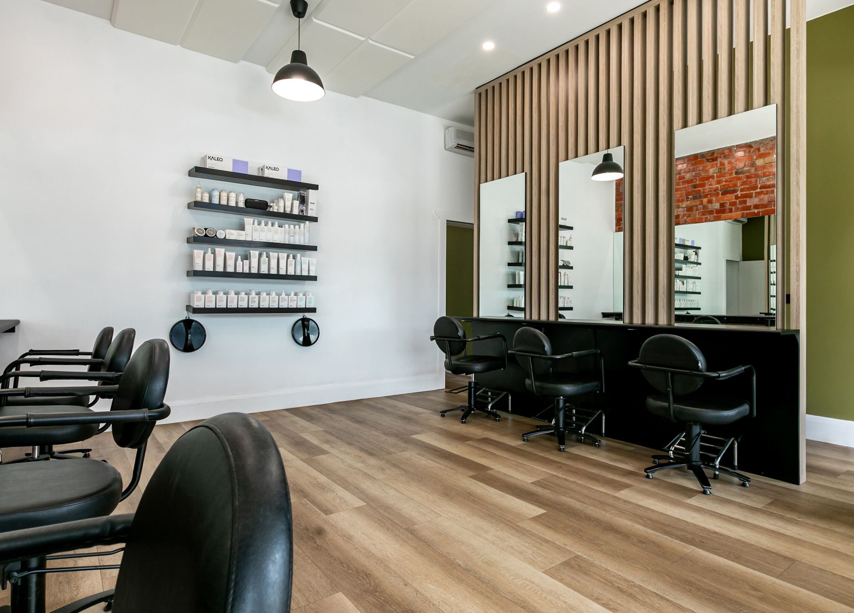 Modern interior of SP Salon in Melbourne, Victoria, AU showcasing sleek styling stations and product shelves.