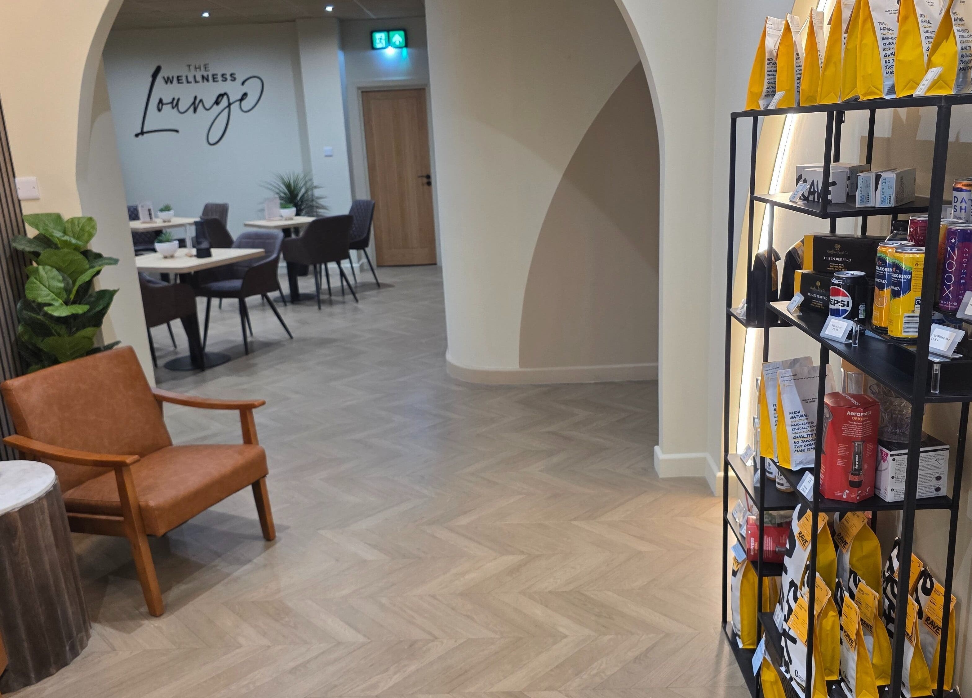 Inviting interior of The Wellness Lounge in Cardiff, Wales, GB, featuring seating and a product display area.