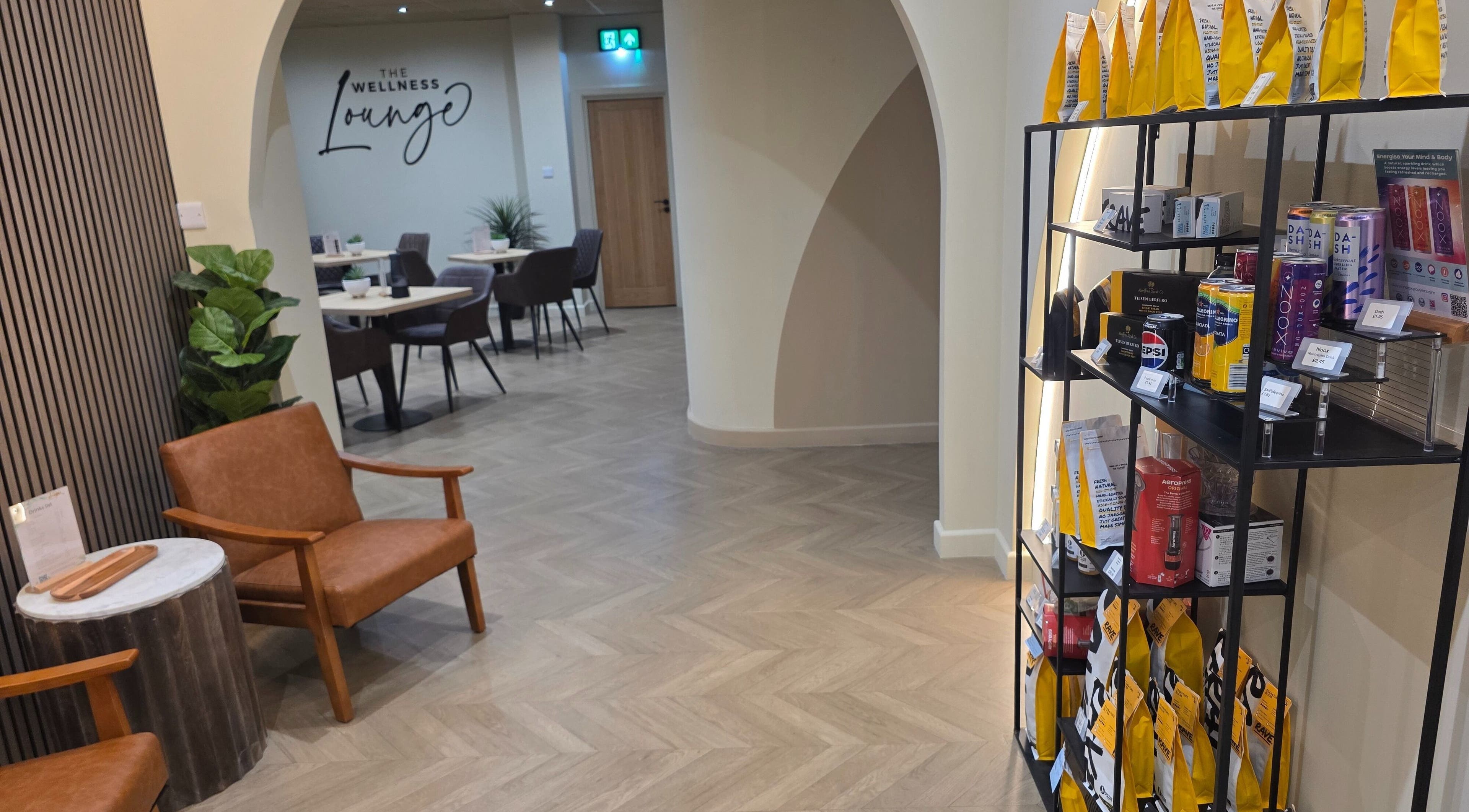 Inviting interior of The Wellness Lounge in Cardiff, Wales, GB, featuring seating and a product display area.