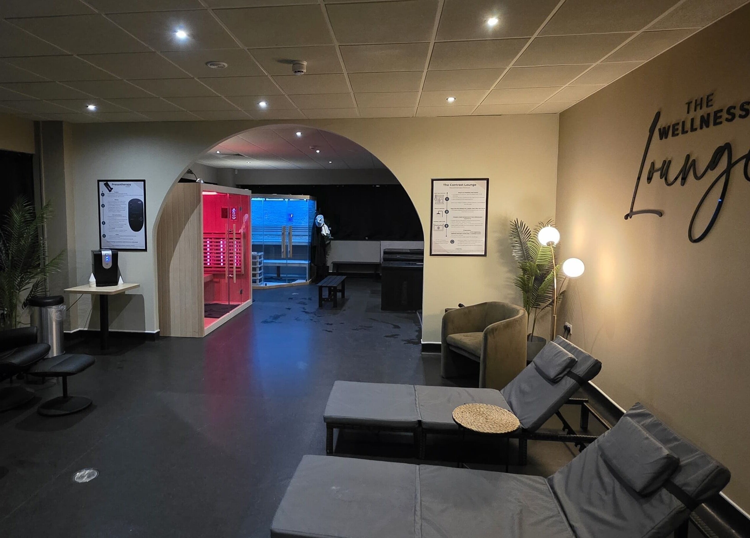 Tranquil interior of The Wellness Lounge, Cardiff, Wales, GB, featuring relaxing chairs and a modern sauna.