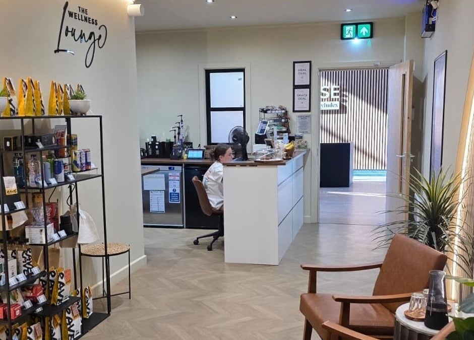 Reception area of The Wellness Lounge in Cardiff, Wales, GB featuring a stylish seating area and display shelves.