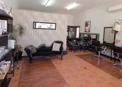 Chic interior of Creations by Linda salon in Melbourne, Victoria, AU, featuring stylish seating and workstations.