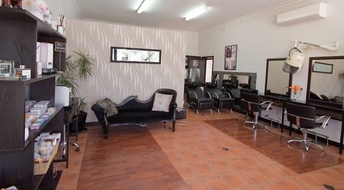 Chic interior of Creations by Linda salon in Melbourne, Victoria, AU, featuring stylish seating and workstations.