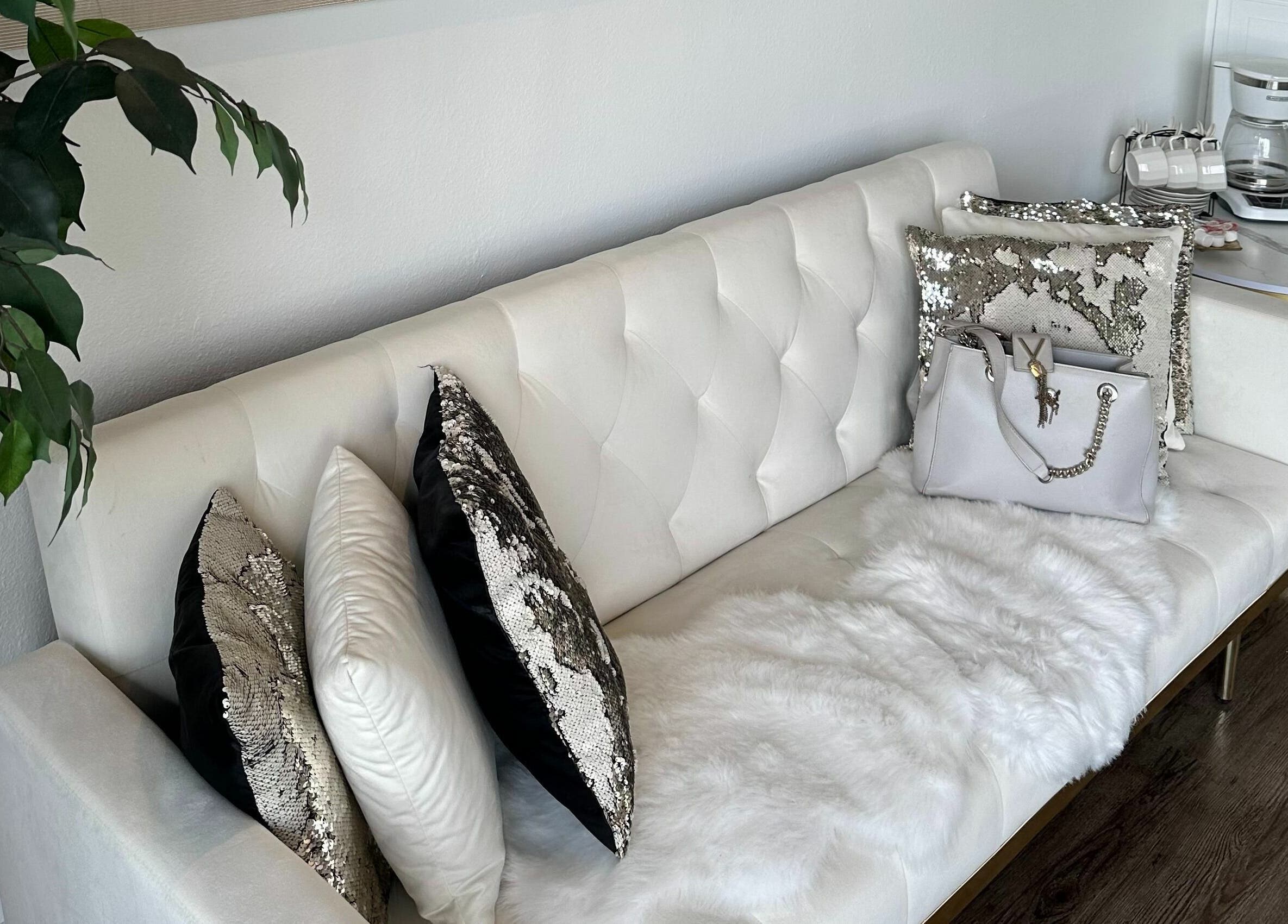 Elegant white sofa with decorative pillows at Lash Ology And Spa Cocoa, Cocoa, Florida, US.