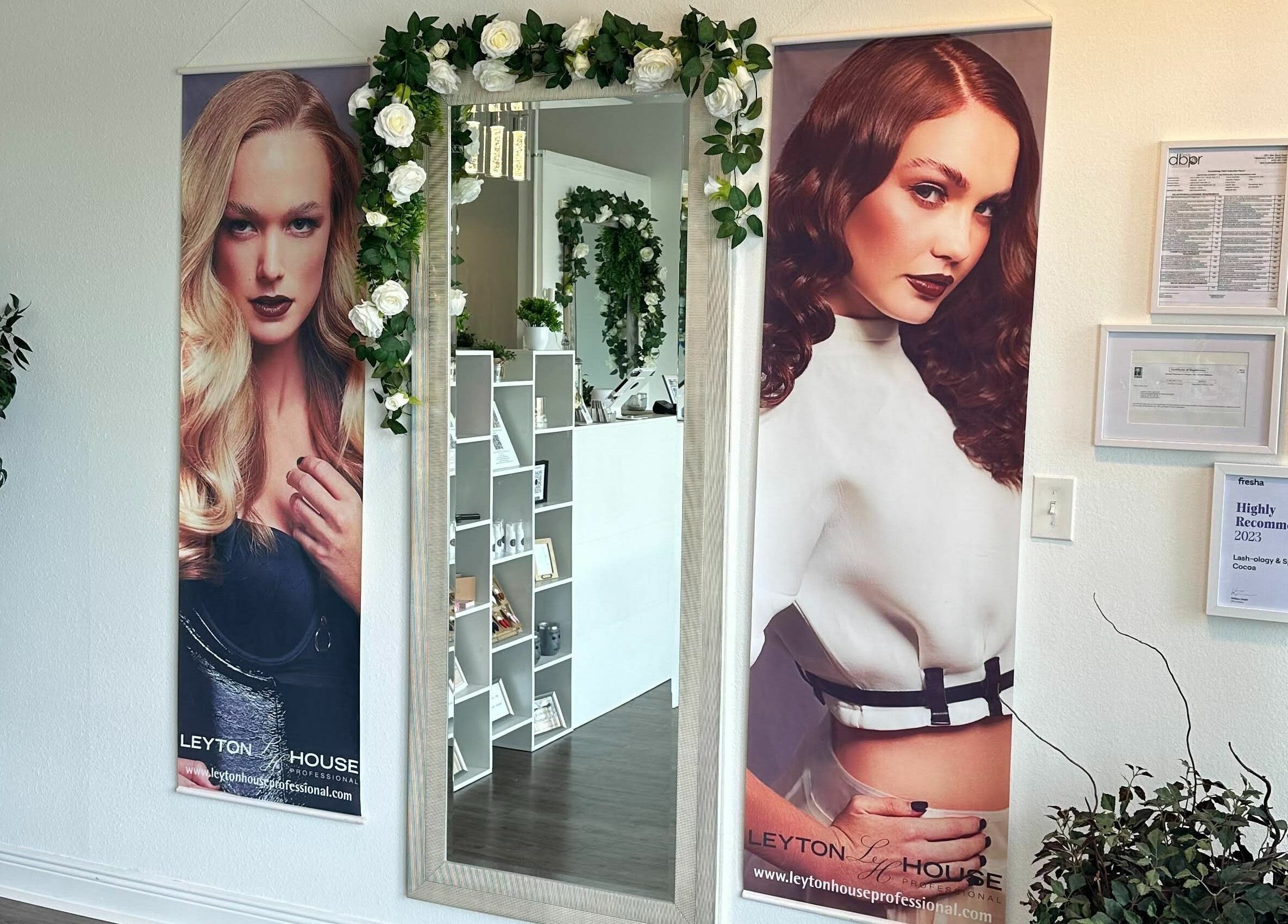 Stylish entrance at Lash Ology And Spa Cocoa in Cocoa, Florida, US, featuring chic posters and a decorative mirror.