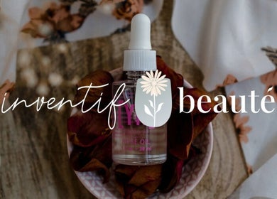Inventif Beauté Mossel Bay features rose oil on floral fabric backdrop.