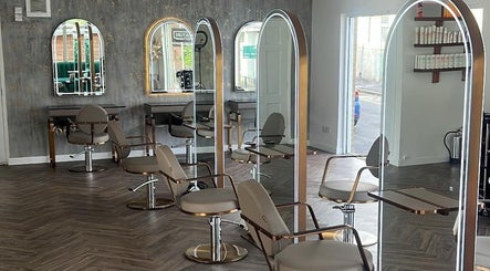 Modern salon interior at Jen Wilson Hair, Kirkintilloch, Scotland, GB, featuring sleek styling chairs and mirrors.