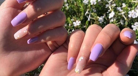 Lavender manicured nails with floral accents at Adorn Salon, Durban, KwaZulu-Natal, ZA.