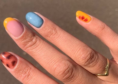 Bright nail art at Adorn Salon, Durban, KwaZulu-Natal, ZA showcasing colorful themed manicure.