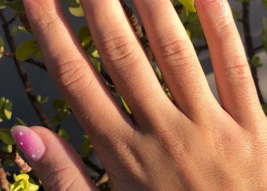 Manicured hand with floral nail art at Adorn Salon, Durban, KwaZulu-Natal, ZA.