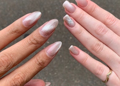 Elegant manicured nails at Adorn Salon, Durban, KwaZulu-Natal, ZA showcasing shimmer effect.
