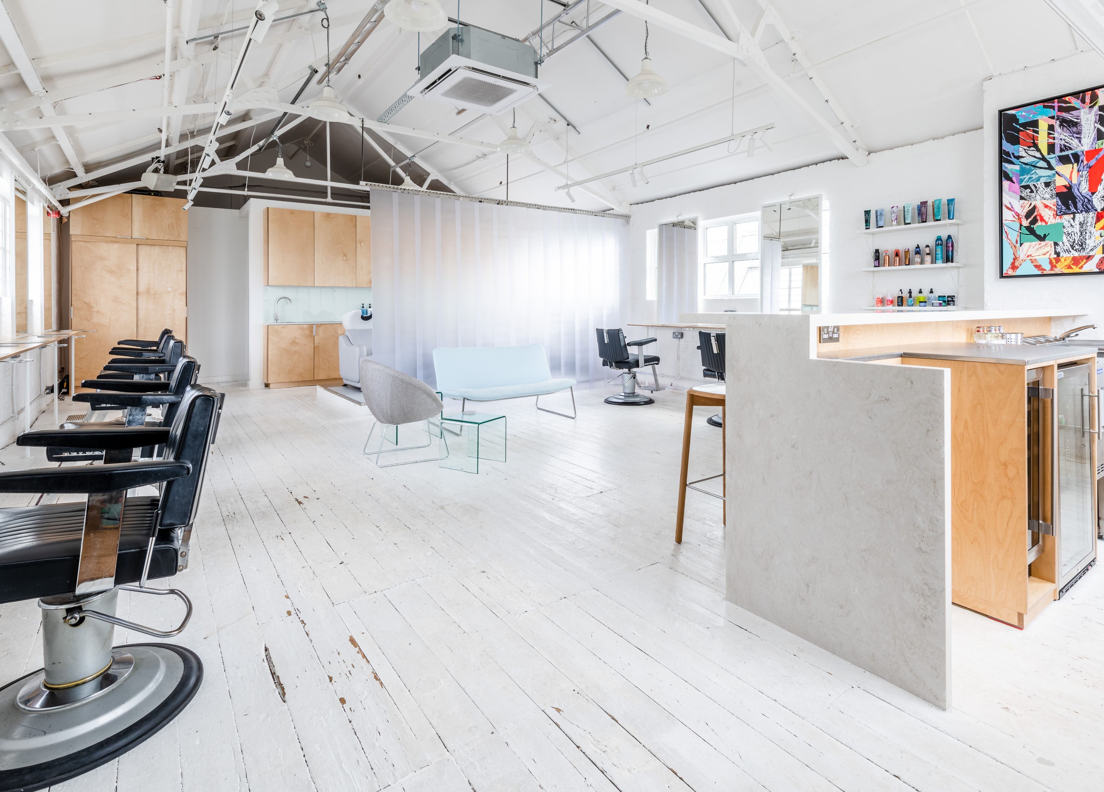 Interior of SALT Salon Hackney, featuring modern styling chairs and minimal decor in London, England, GB.