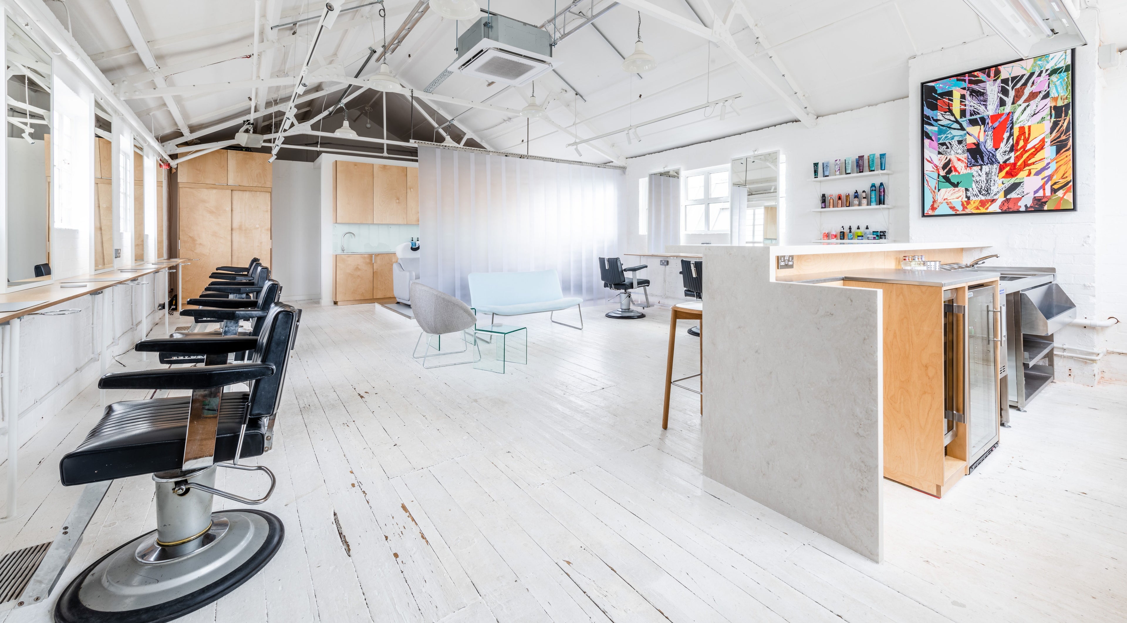 Interior of SALT Salon Hackney, featuring modern styling chairs and minimal decor in London, England, GB.