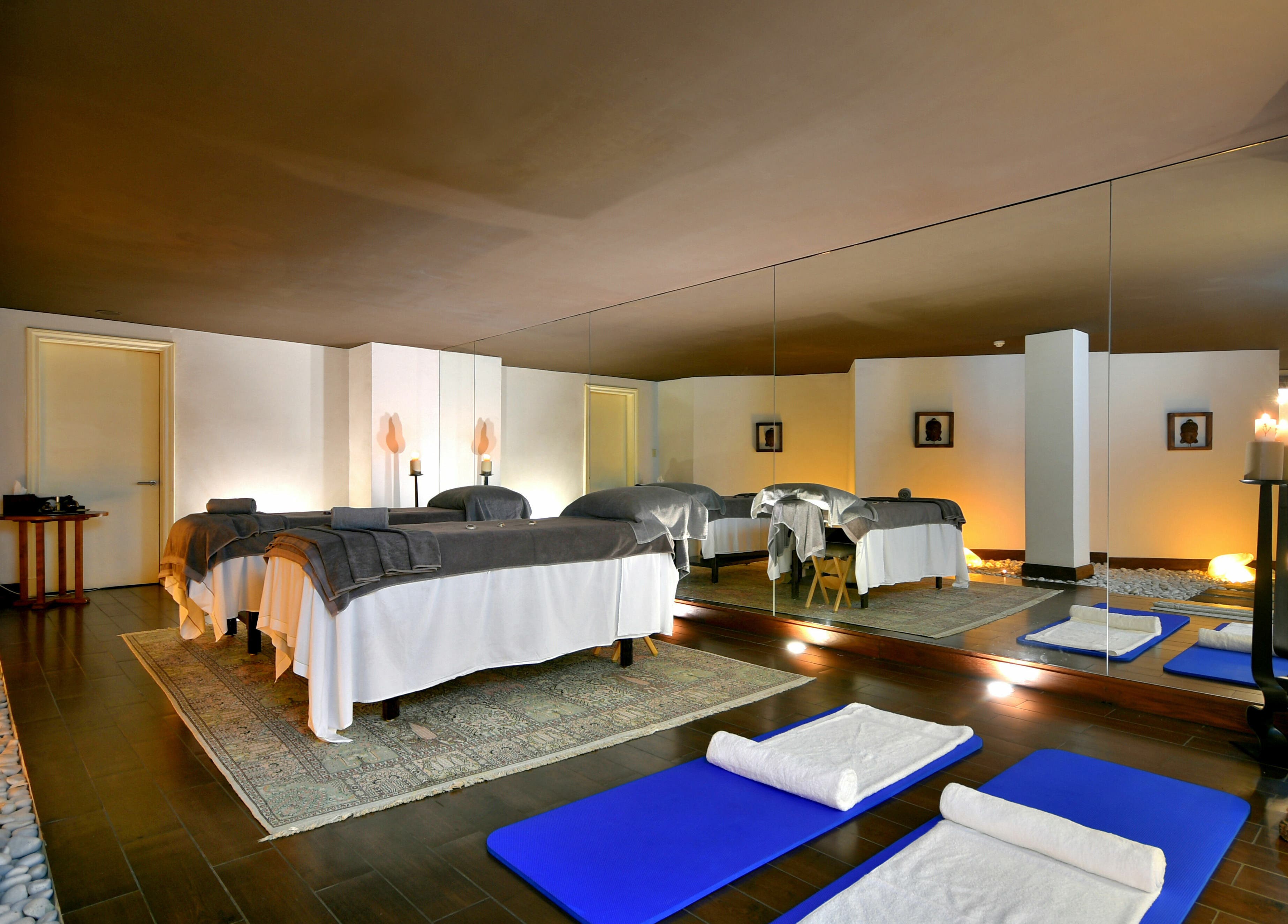 Relaxing spa room at The Residence Mauritius, ., Flacq District, MU featuring massage tables and yoga mats.