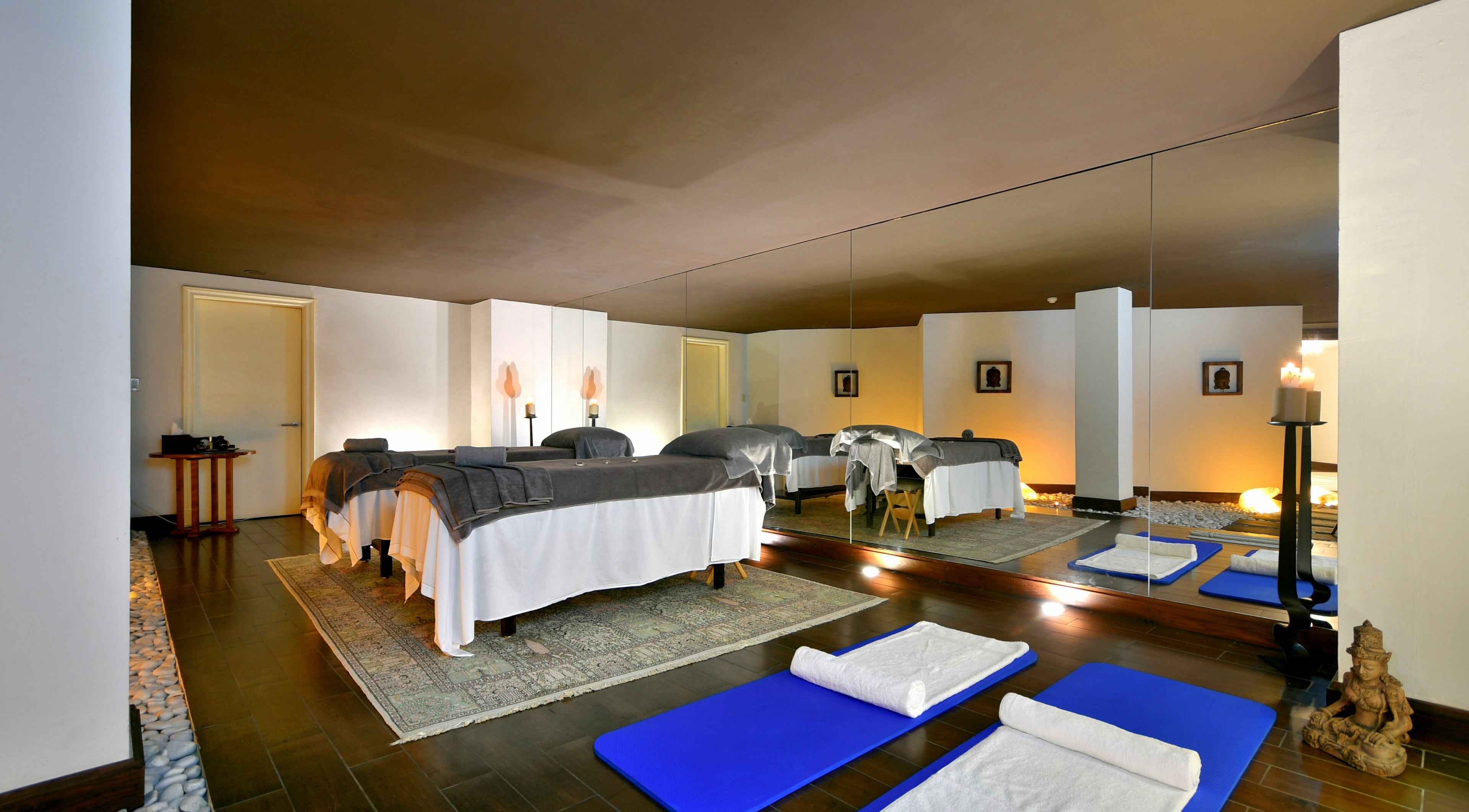 Relaxing spa room at The Residence Mauritius, ., Flacq District, MU featuring massage tables and yoga mats.
