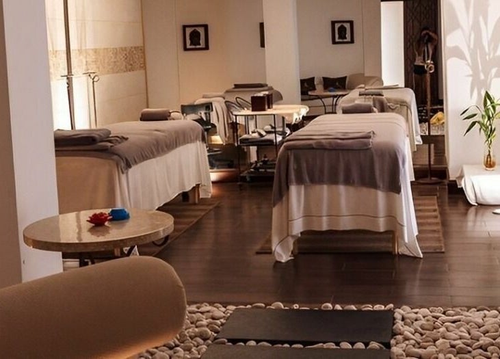 Tranquil spa room at The Residence Mauritius, Flacq District, MU, featuring massage tables and ambient lighting.