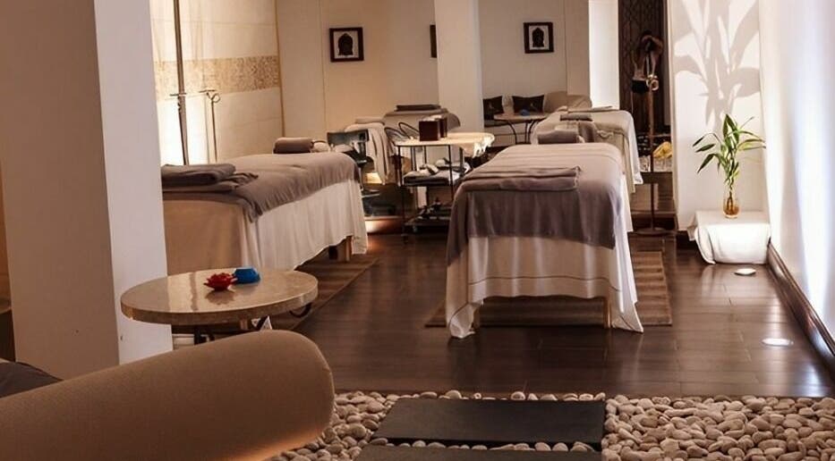 Tranquil spa room at The Residence Mauritius, Flacq District, MU, featuring massage tables and ambient lighting.