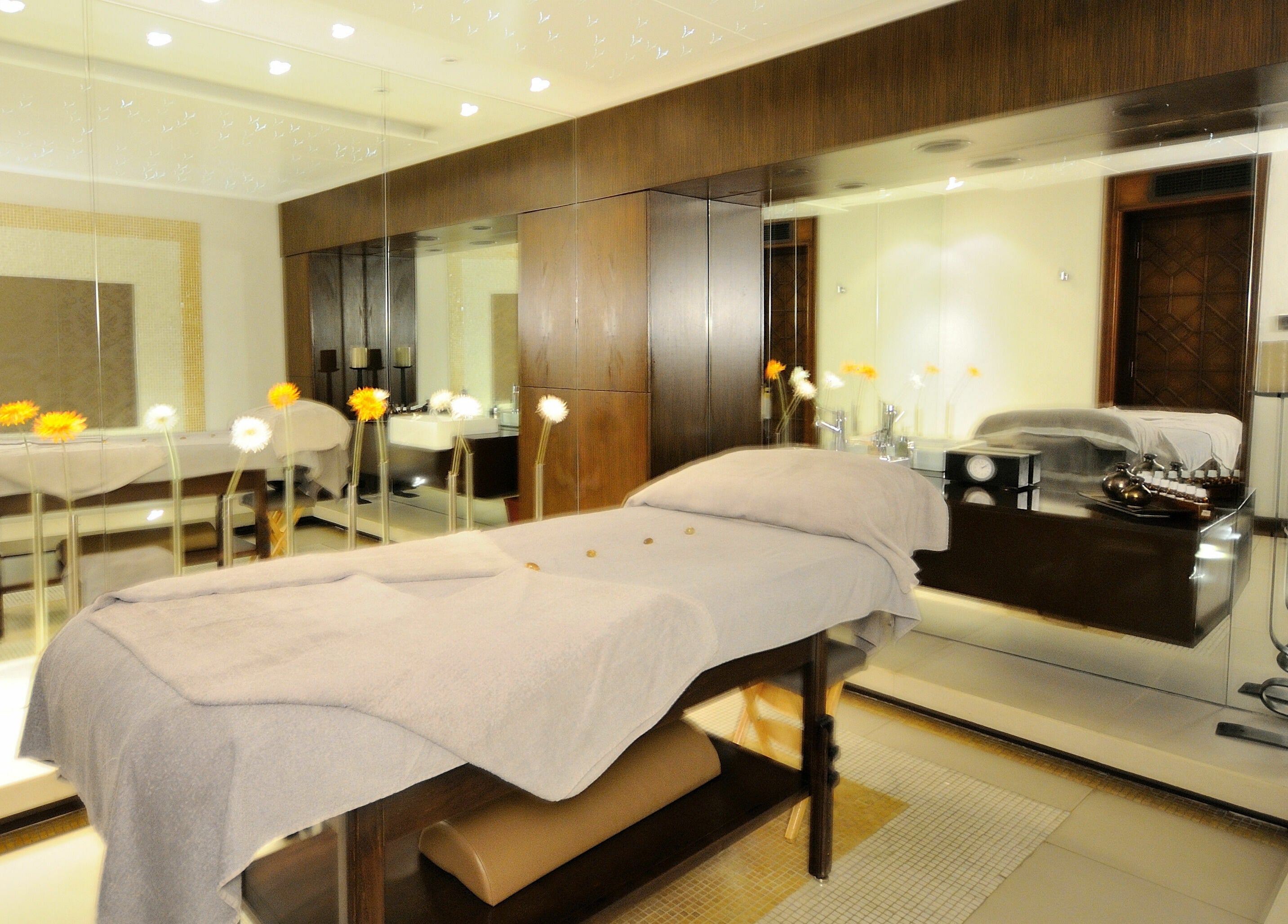 Relaxing spa room at The Residence Mauritius, Flacq District, MU, featuring a massage table and elegant decor.