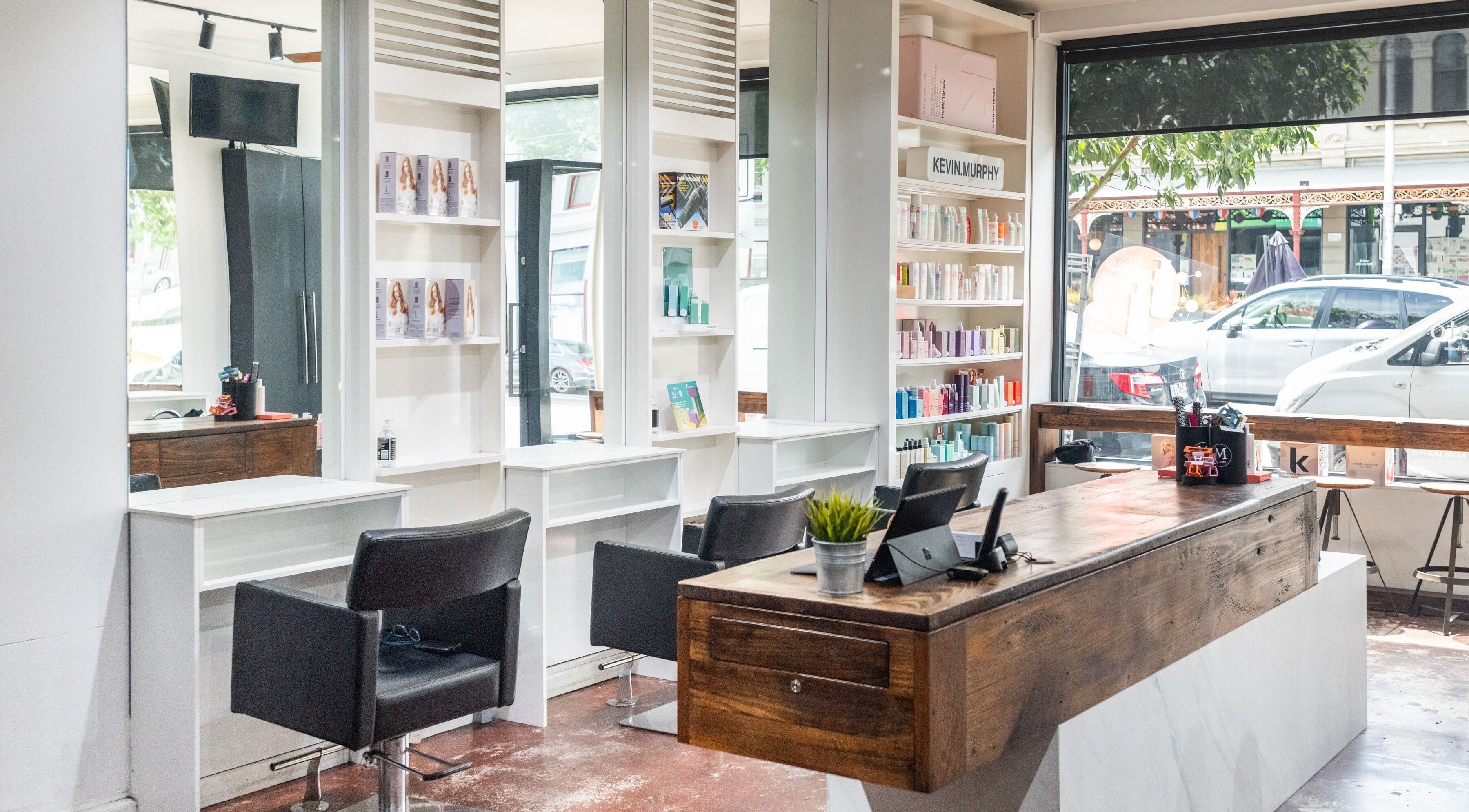 Modern interior of Moscato Hair in West Melbourne, VIC, AU, featuring sleek salon chairs and chic decor.
