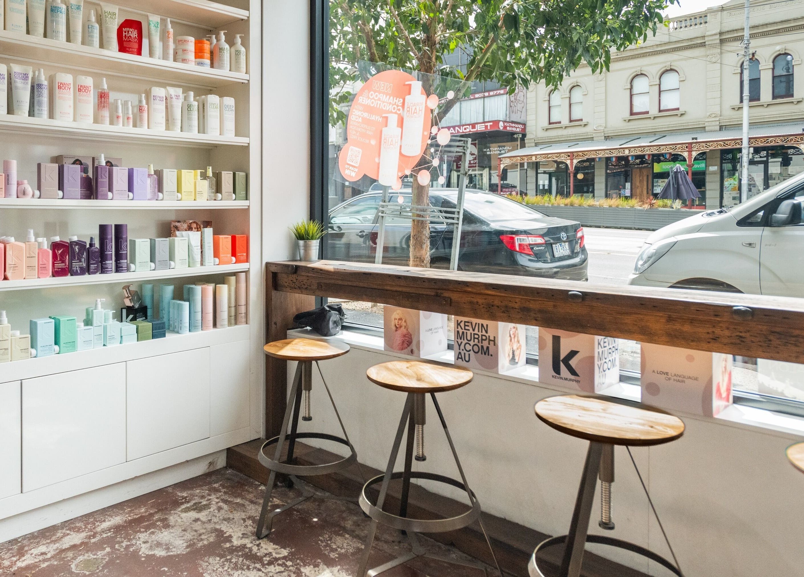 Bright salon product shelves at Moscato Hair, West Melbourne, VIC, AU, featuring vibrant beauty items.