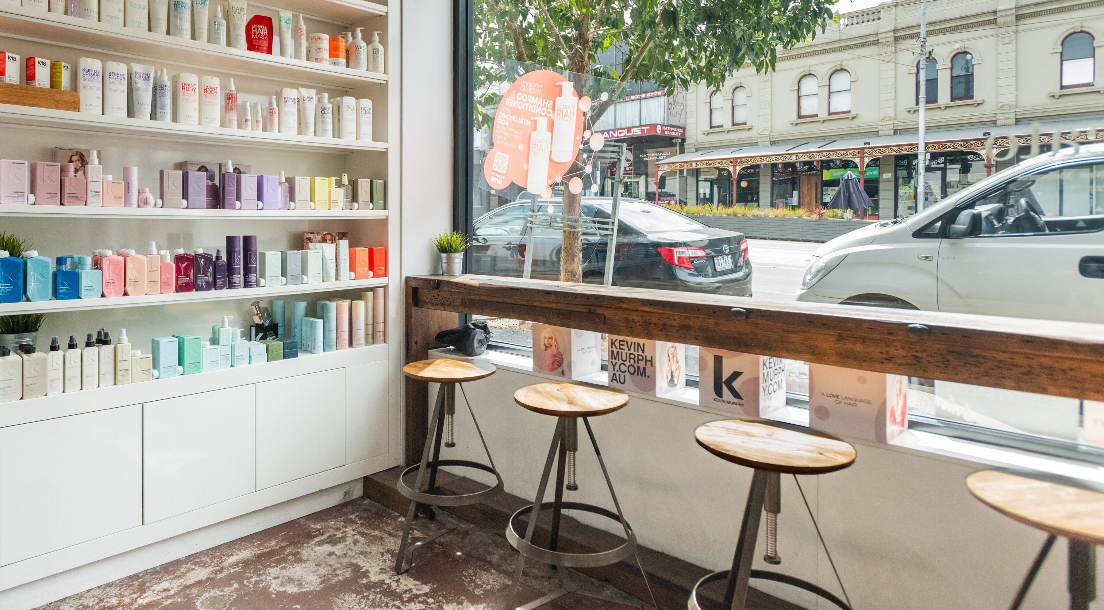 Bright salon product shelves at Moscato Hair, West Melbourne, VIC, AU, featuring vibrant beauty items.