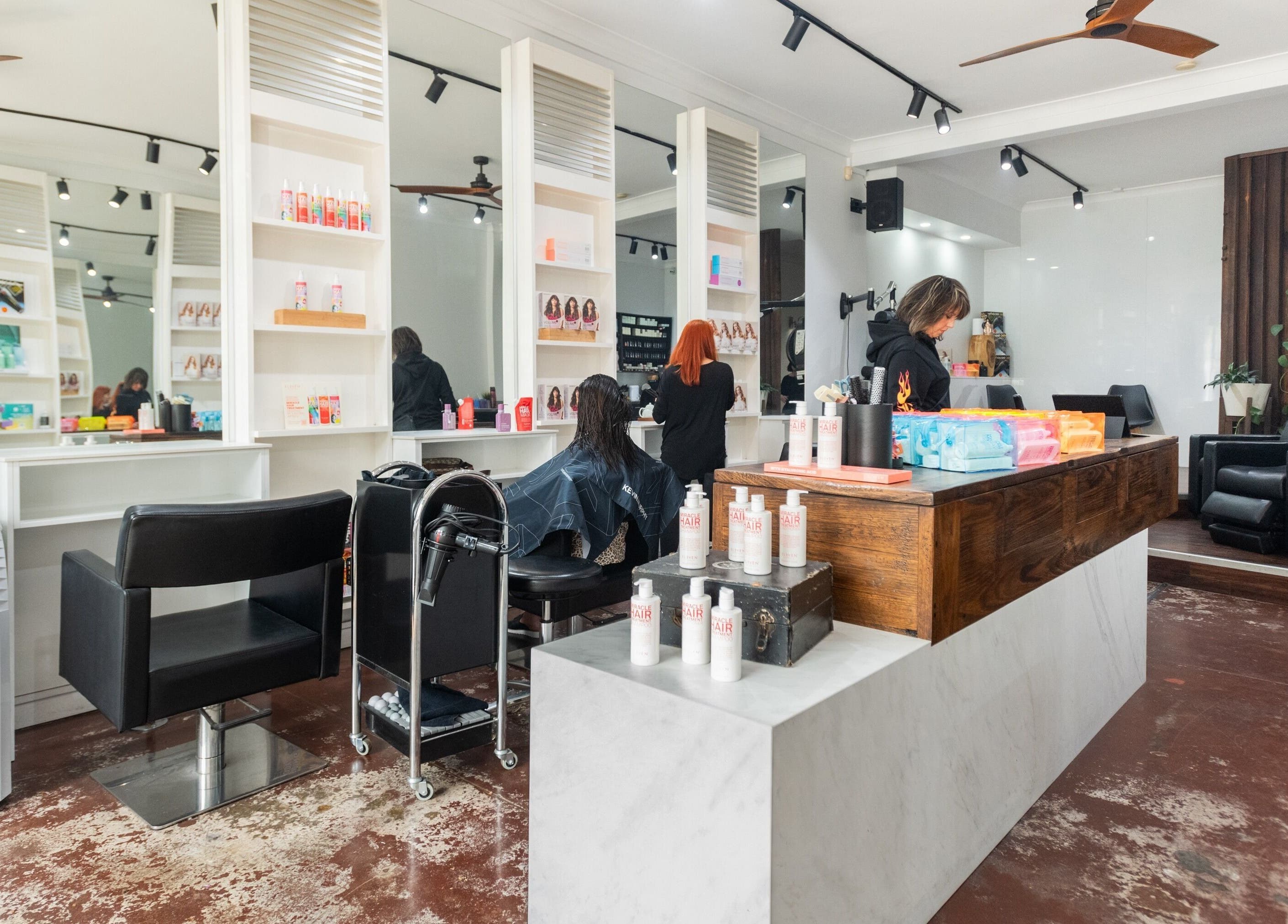 Modern interior of Moscato Hair salon, West Melbourne, VIC, AU, featuring stylish decor and hair care products.